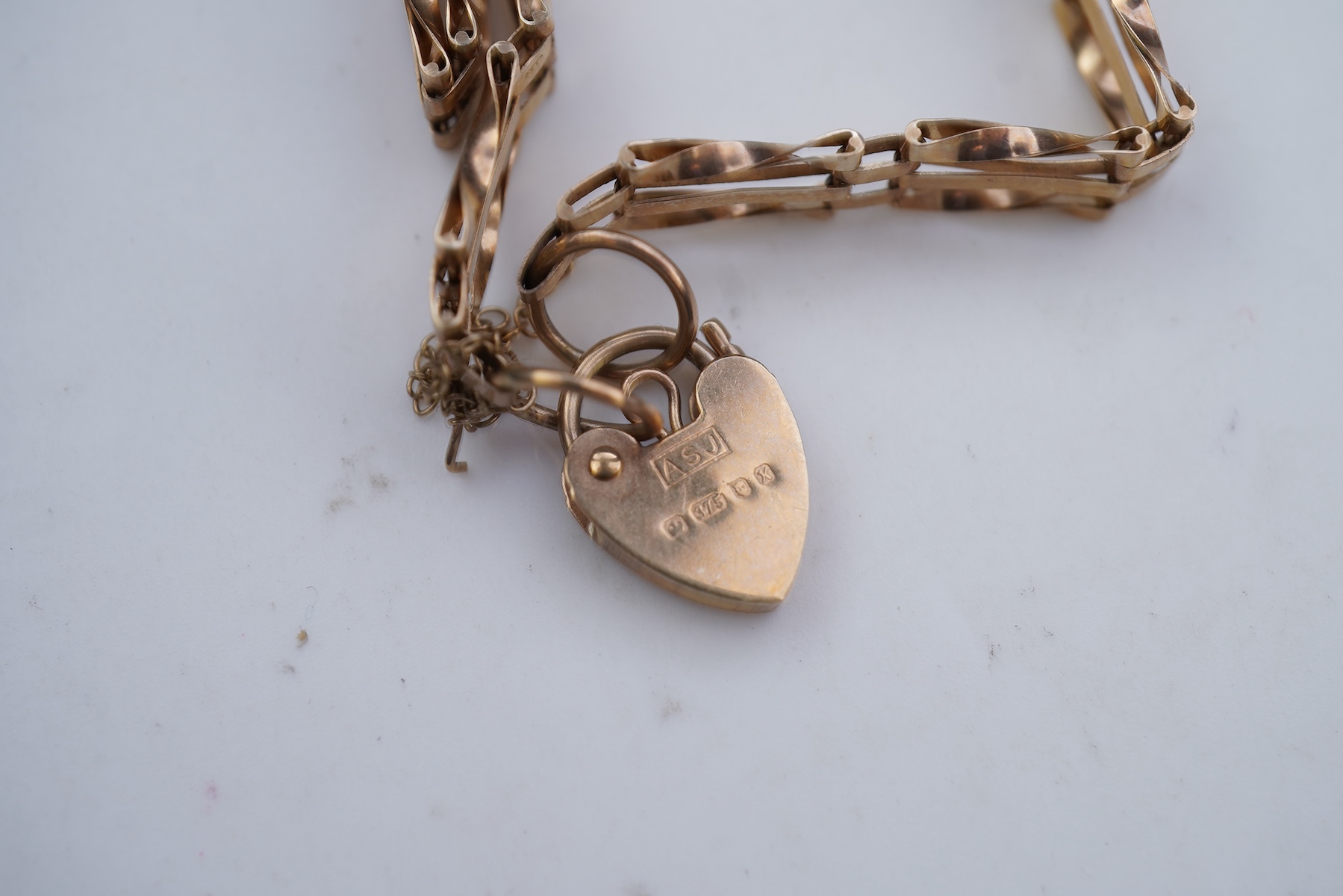 Two gold bracelets and a gold necklace